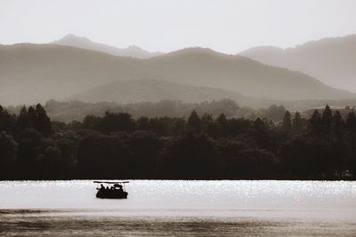 Scenic view of river and mountains against sky