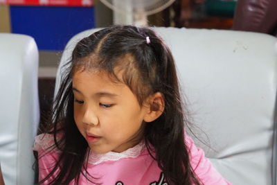 Portrait of cute girl looking down