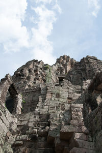 Low angle view of rock formation against sky