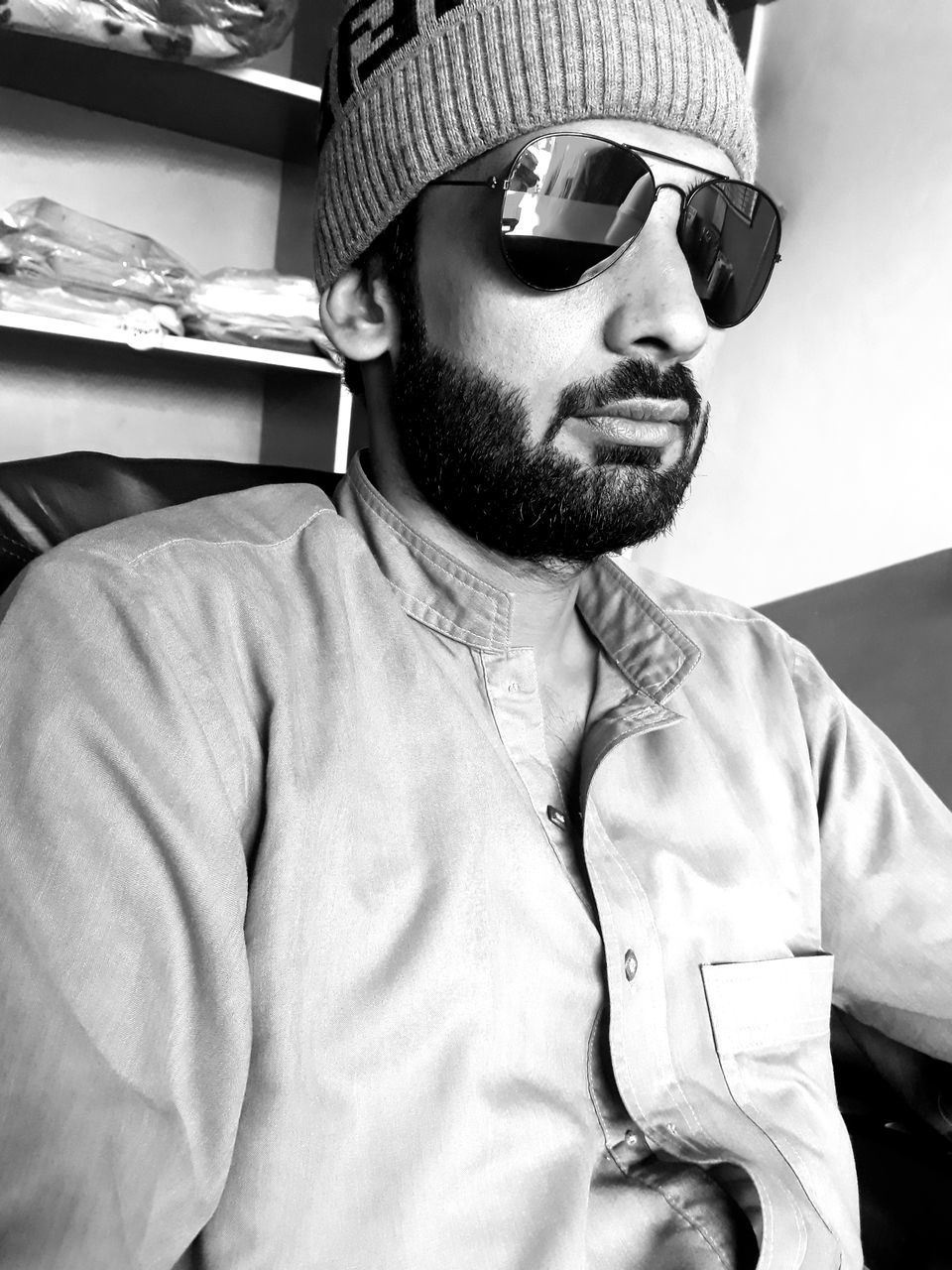 white, black and white, one person, glasses, eyewear, adult, fashion, sunglasses, men, monochrome photography, monochrome, vision care, facial hair, portrait, black, young adult, person, hat, clothing, beard, lifestyles, waist up, indoors, cap, fashion accessory, leisure activity, music, headshot, arts culture and entertainment, front view, looking, casual clothing, relaxation, hairstyle