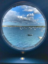 Scenic view of sea against sky seen through window