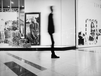 Blurred motion of people walking on tiled floor