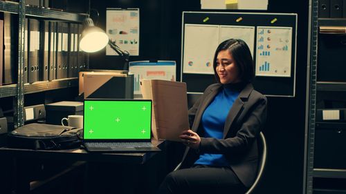 Portrait of businesswoman using laptop in office