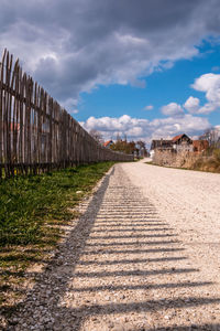 Surface level of road amidst buildings against sky