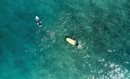 High angle view of people kayaking in sea