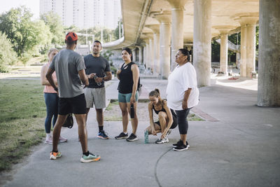 Male fitness instructor assisting team during training session