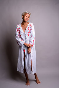 Woman standing against white background