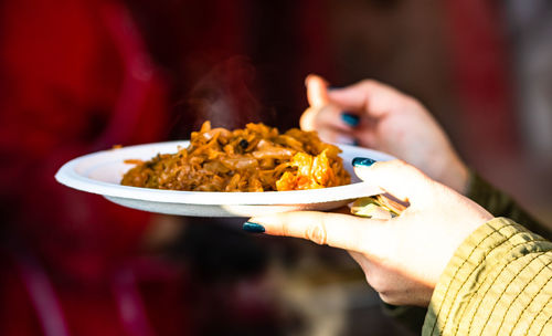 Cropped hand holding food