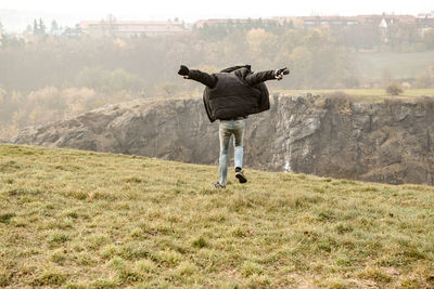 Rear view of man on field