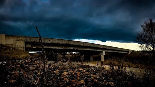 View of abandoned building against cloudy sky