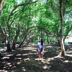 Full length of woman walking in forest