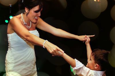 Mother and son dancing at party