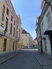 Empty alley amidst buildings in city
