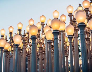 Low angle view of illuminated lights against sky