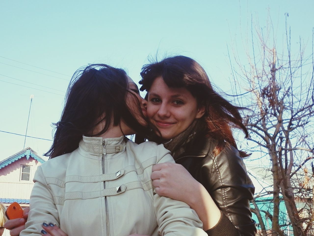 lifestyles, person, young adult, leisure activity, casual clothing, waist up, young women, looking at camera, portrait, long hair, smiling, front view, three quarter length, standing, happiness, clear sky, low angle view, sky