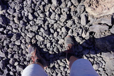 Low section of man standing on rock