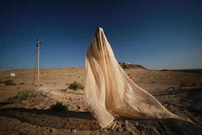 Scenic view of desert against clear blue sky