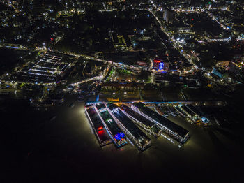 High angle view of illuminated street amidst buildings in city