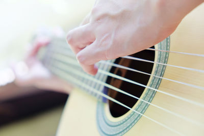 Close-up of hand playing guitar