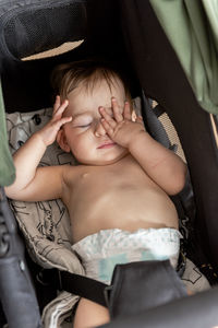 Baby child sleeping in her buggy / stroller.