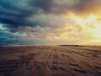 Scenic view of beach against sky during sunset