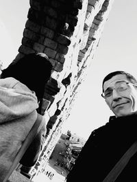 Low angle view of man and buildings against clear sky