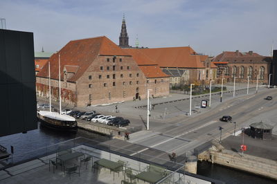 High angle view of buildings by road against sky
