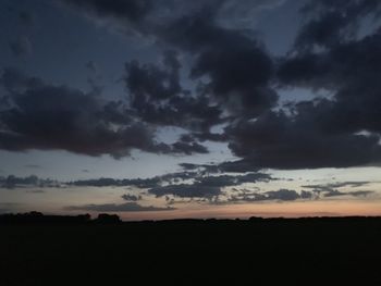 Scenic view of dramatic sky over silhouette landscape