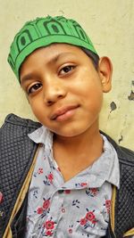 Portrait of smiling boy against wall