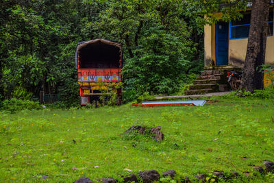 Abandoned truck on field in forest