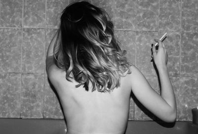 Rear view of a girl in the bathroom