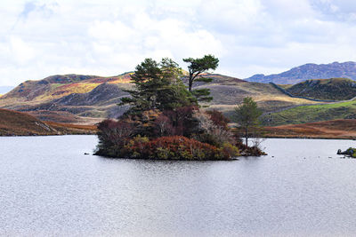 Scenic view of lake and mountains against sky