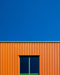 Low angle view of house against clear blue sky