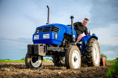 A farmer on a tractor cleans the field after harvest. preparation of land for future planting 