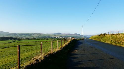 Scenic view of agricultural field against clear blue sky