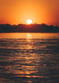 Scenic view of sea against romantic sky at sunset