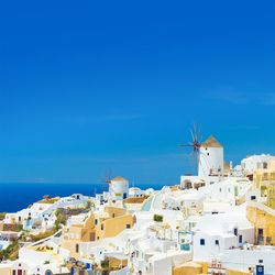 Cityscape against clear blue sky