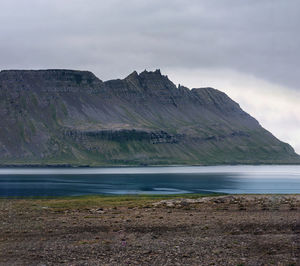 Scenic view of sea and mountains against sky