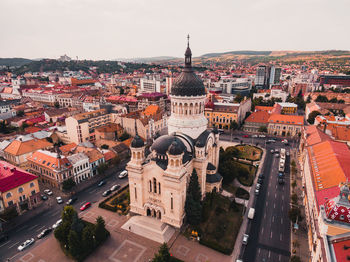 Aerial view of church in city against sky