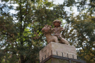 Low angle view of statue against trees