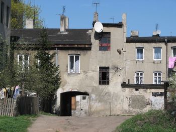 Exterior of old building in town against clear sky