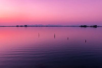 Scenic view of lake against sky during sunset