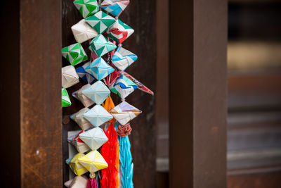 Close-up of colorful decoration hanging on wood