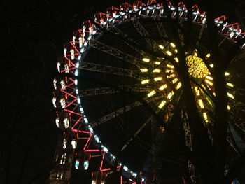 Low angle view of ferris wheel at night