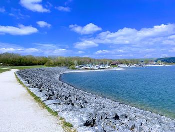Scenic view of lake against blue sky