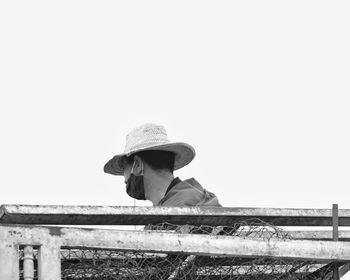 Portrait of man in hat against clear sky