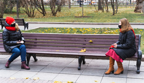 People sitting on bench in park