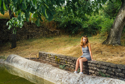 Full length of woman sitting in park