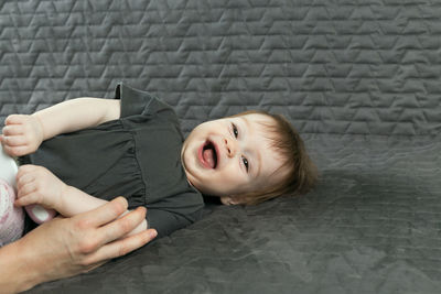 High angle portrait of cute boy lying on floor