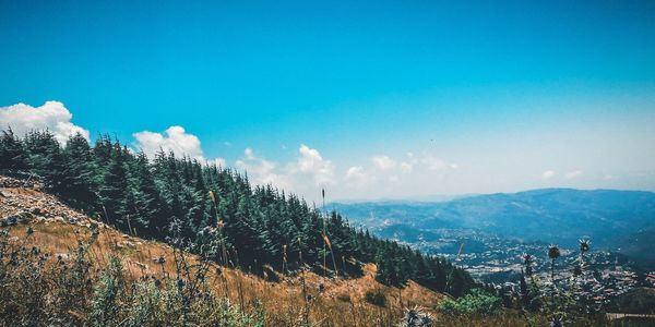 Panoramic view of landscape against blue sky